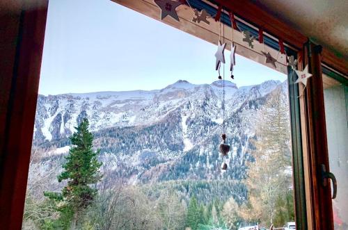 a window with a view of a mountain at Residence “I Larici” Folgarida in Folgarida