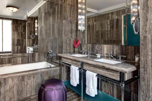 a bathroom with two sinks and a tub at The St. Regis New York in New York