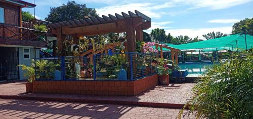a garden center with a wooden fence and flowers at Villa Lenda Resort - San Manuel, Pangasinan 