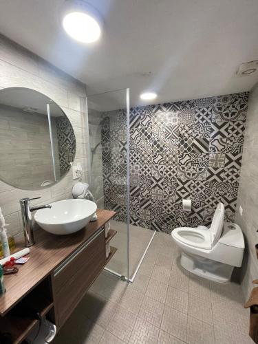 a bathroom with a toilet and a sink and a shower at Casa Praxedis in Santiago