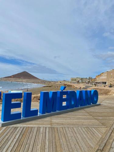 a sign for el meldo on a beach at Suite El Médano Experimental II in El Médano