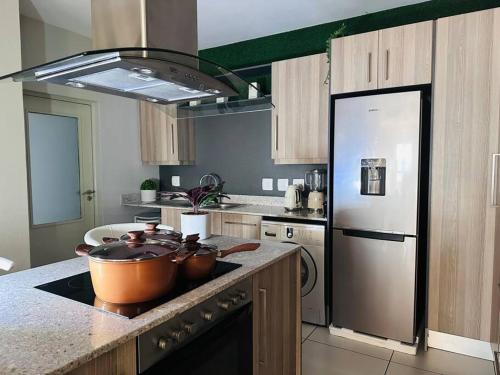 a kitchen with two pots on the stove top at D&DLuxury Rivonia Apartments with inverter in Johannesburg