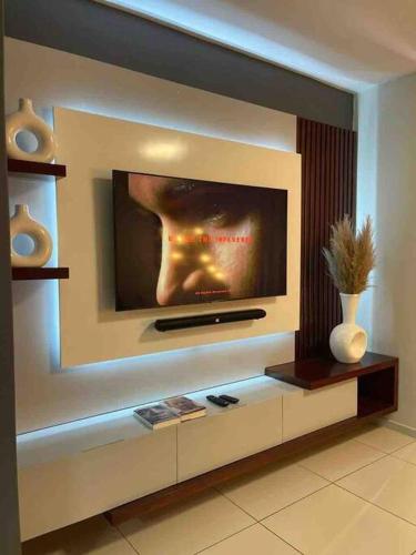 a flat screen tv on a wall in a living room at D&DLuxury Rivonia Apartments with inverter in Johannesburg