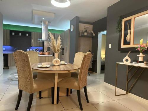 a dining room with a table and chairs at D&DLuxury Rivonia Apartments with inverter in Johannesburg