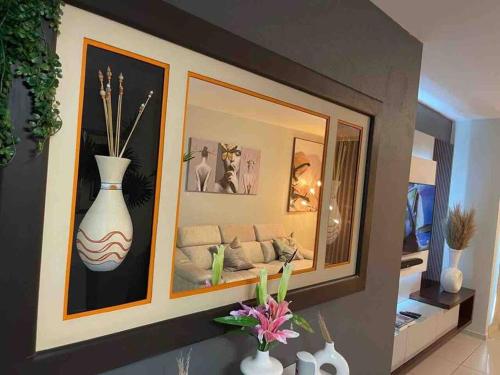 a living room with a couch and pictures on the wall at D&DLuxury Rivonia Apartments with inverter in Johannesburg