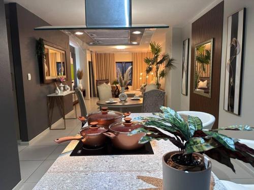 a kitchen with pots and pans on a table at D&DLuxury Rivonia Apartments with inverter in Johannesburg