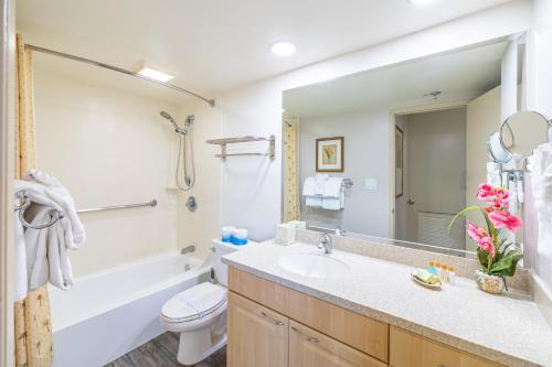 a bathroom with a sink and a toilet and a mirror at Great Ocean View at Waikiki Sunset with Parking in Honolulu