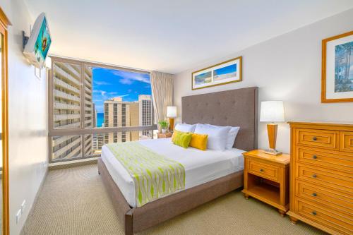 a bedroom with a bed and a large window at Great Ocean View at Waikiki Sunset with Parking in Honolulu