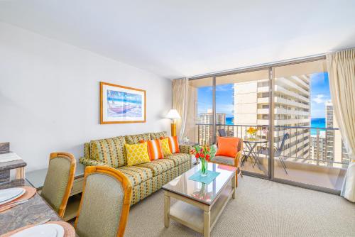 a living room with a couch and a large window at Great Ocean View at Waikiki Sunset with Parking in Honolulu