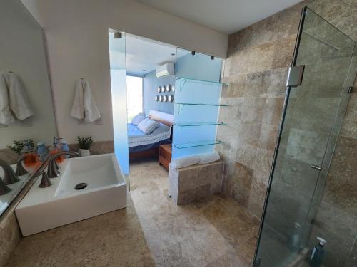 a bathroom with a sink and a shower and a bed at Lovely 4 bedroom penthouse Terra PH23 QueridaEstancia in Nuevo Vallarta 