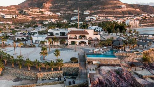 an aerial view of a resort with a mountain at Orchid House Baja in La Paz