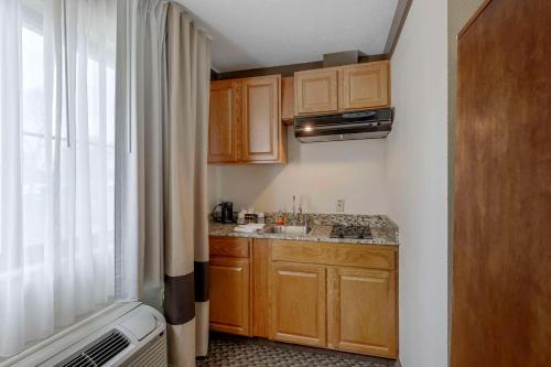 a small kitchen with a sink and a window at Comfort Inn Mount Vernon Downtown in Mount Vernon
