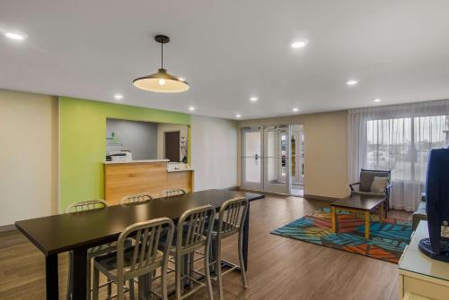 a dining room with a table and chairs at WoodSpring Suites Jacksonville Orange Park in Orange Park