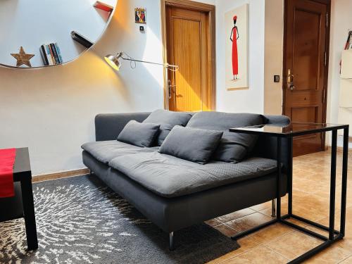 a living room with a couch and a table at Ático Centro Málaga in Málaga