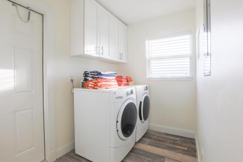 a white laundry room with a washer and dryer at The GUAVA DUFF - Beautiful KW home with space to chill & lots of FREE PARKING!! in Key West