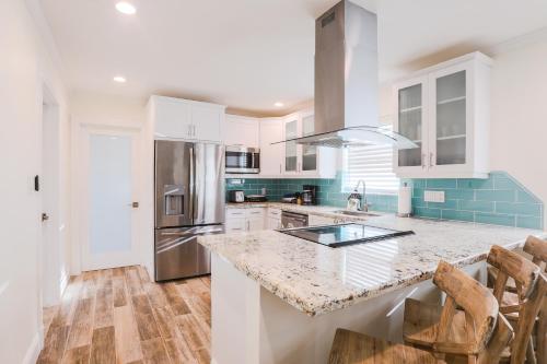 a kitchen with white cabinets and a granite counter top at The GUAVA DUFF - Beautiful KW home with space to chill & lots of FREE PARKING!! in Key West