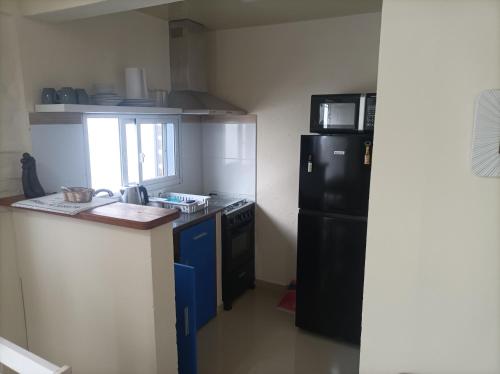 梅塞德斯的住宿－Lavalleja 71，厨房配有黑色冰箱和台面