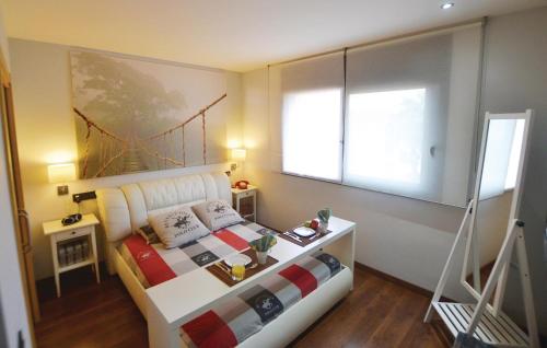 a bedroom with a bed with a bridge painting on the wall at Amazing Home In Santa Susanna With Kitchen in Santa Susanna