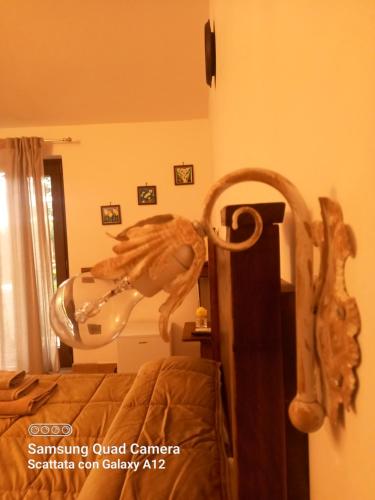 a room with a bed and a mirror with a horse head at B&B da Maria Teresa - Maratea in Maratea