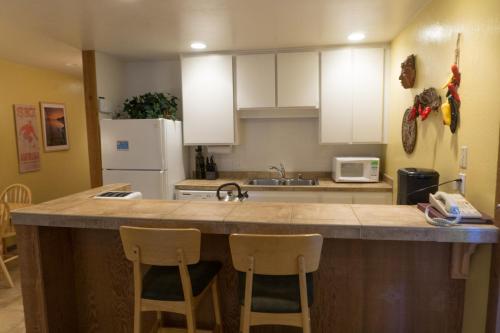 a kitchen with a large island with two bar stools at 4081 Ski Trails in Truckee