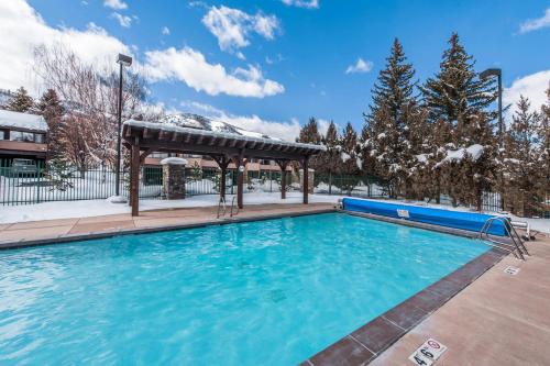 a swimming pool with a gazebo in the snow at Park Avenue Upgraded 2 Bedroom Condominiums in Park City