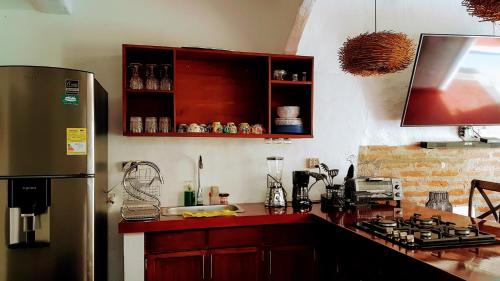 a kitchen with a refrigerator and a counter top at Casa San Francisco Honda in Honda