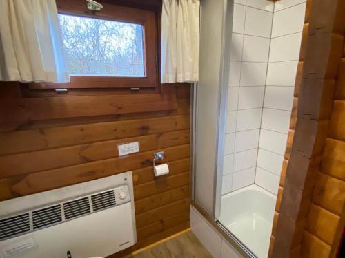a bathroom with a shower and a air conditioner at Cozy holiday home on a horse farm in the Lüneburg Heath in Eschede