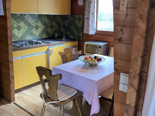a kitchen with a table with a bowl of fruit on it at Cozy holiday home on a horse farm in the Lüneburg Heath in Eschede