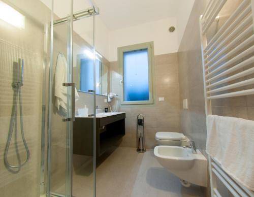 a bathroom with a shower and a sink and a toilet at 29 Cav Apartments in Bollate