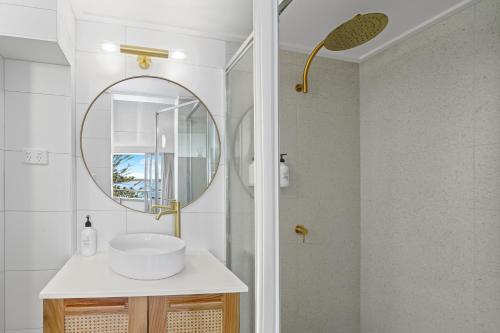 a bathroom with a sink and a mirror at The Mid Pacific in Port Macquarie