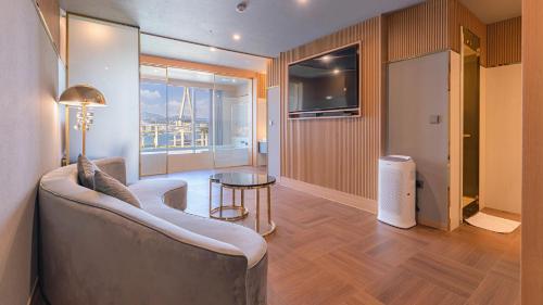 a living room with a couch and a table at Yeongdo Grandbern Hotel in Busan