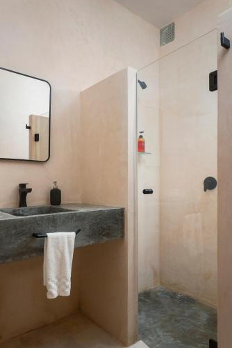 a bathroom with a sink and a shower at Rodina - Hotel Boutique in Playa del Carmen