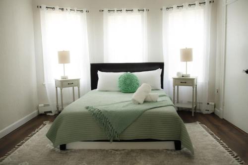 a bedroom with a bed with a teddy bear on it at Cozy Getaway in Everett