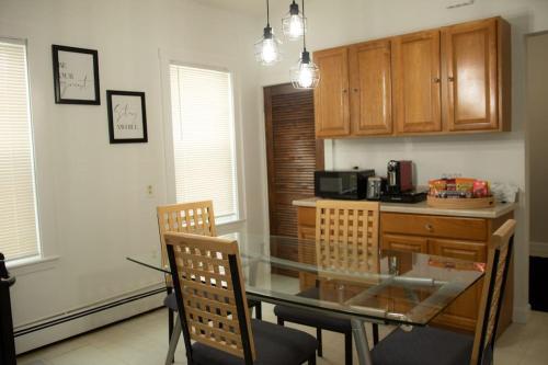 a kitchen with a glass table and two chairs at Cozy Getaway in Everett