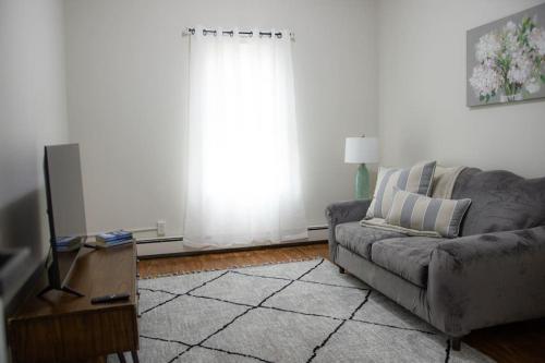 a living room with a couch and a window at Cozy Getaway in Everett
