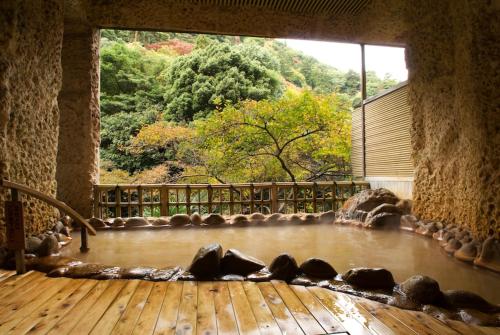 a room with a large window with a view of a mountain at Arima Onsen Gekkoen Korokan in Kobe