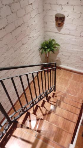 a staircase in a room with a plant on a wall at Aires del Cerro in Yerba Buena