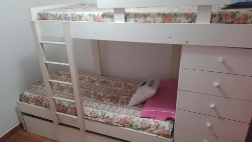 a white bunk bed with a dresser and a drawer at Aires del Cerro in Yerba Buena