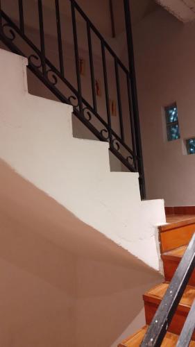 a staircase in a house with a white stair case at Aires del Cerro in Yerba Buena