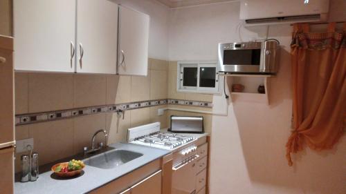 a small kitchen with a sink and a stove at Aires del Cerro in Yerba Buena