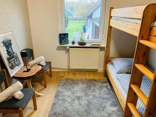 a small room with a bunk bed and a desk at Luhne Boutique Pension in Luhne