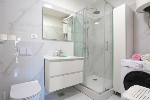 a bathroom with a shower and a sink and a toilet at Apartments with WiFi Split - 20900 in Split