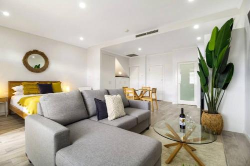 a living room with a couch and a bed at Stylish Studio close to City in Melbourne
