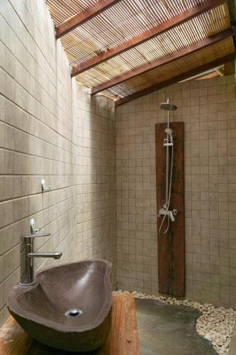 a bathroom with a sink and a shower at Umadhatu Resort by Amerta in Tabanan