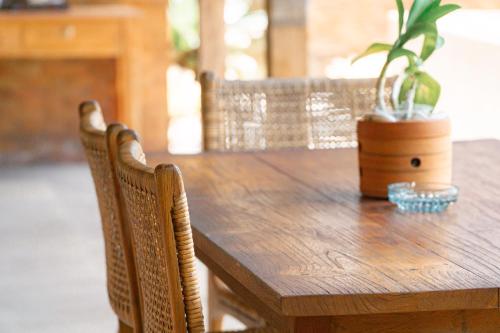 a wooden table with a potted plant on it at Umadhatu Resort by Amerta in Tabanan