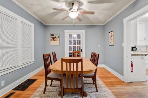 a dining room with a table and a ceiling fan at Cozy Cuse home close to downtown and University in Syracuse