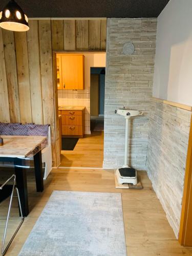 a kitchen with a table and a stove in a room at Luhne Boutique Pension in Rotenburg an der Wümme