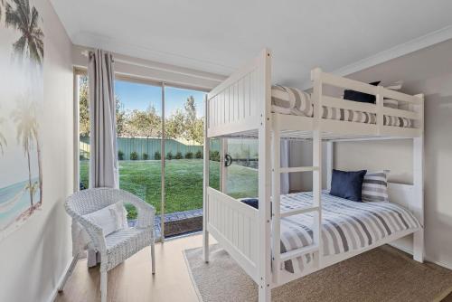 a white bunk bed in a room with a window at Soul Beach House - Belle Escapes Jervis Bay in Vincentia