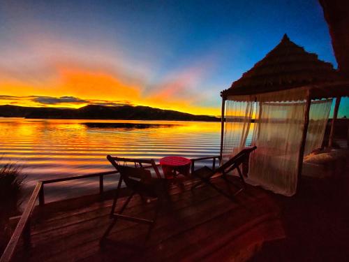 a gazebo with a table and chairs on a dock at Uros Qhantany Lodge in Puno