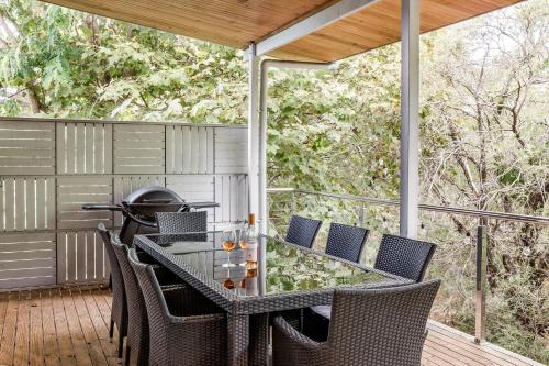 an outdoor table and chairs on a deck at Melaleuca in Dunsborough